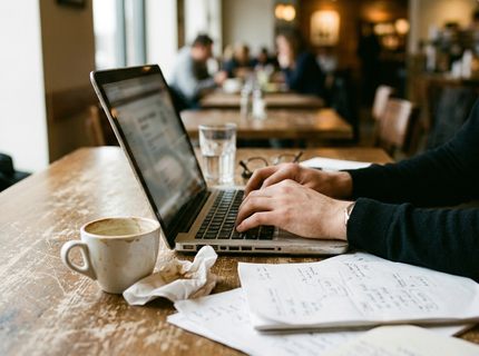 Observational Coffee shop working environment capturing a scratched wooden table